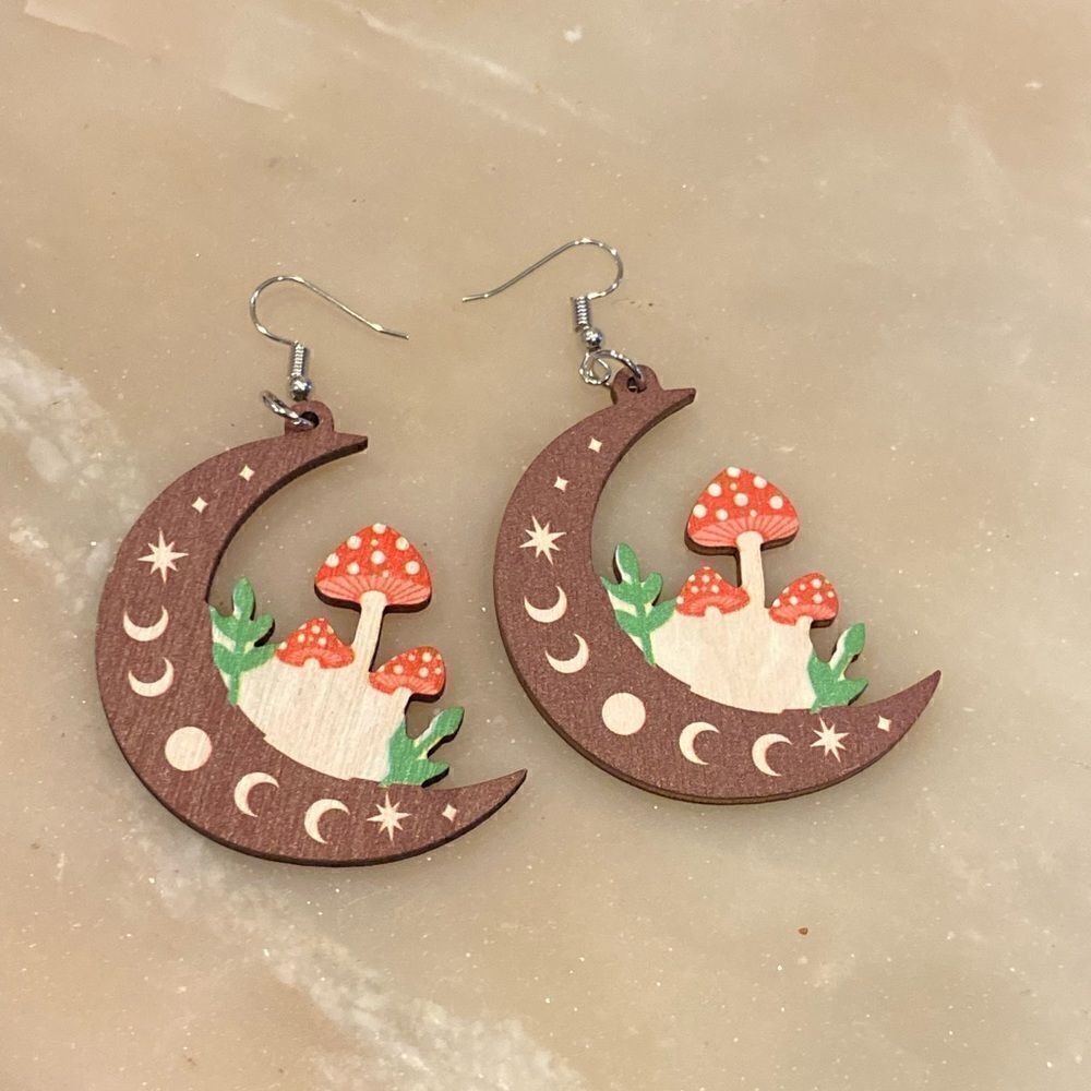 Wooden Moon shaped earrings with mushrooms on them